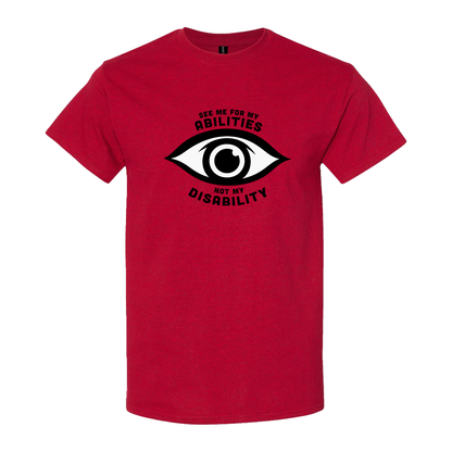 Red t-shirt featuring an eye graphic and the text “See me for my abilities, not my disability.”