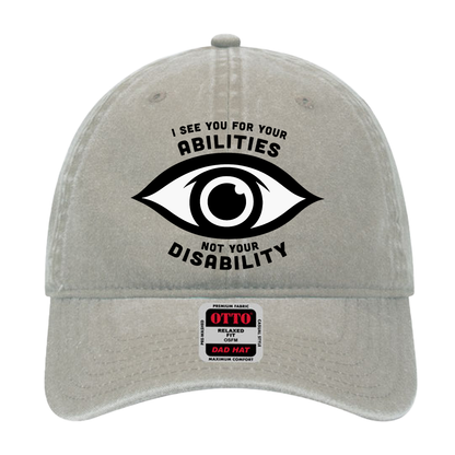 Stone gray dad hat featuring an eye graphic and the text “I see you for your abilities, not your disability.”